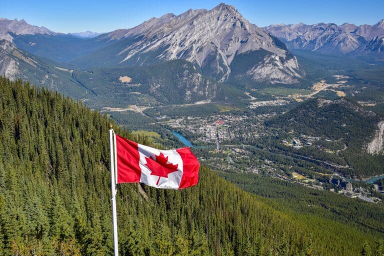 Canadian flag over Rocky Mountains